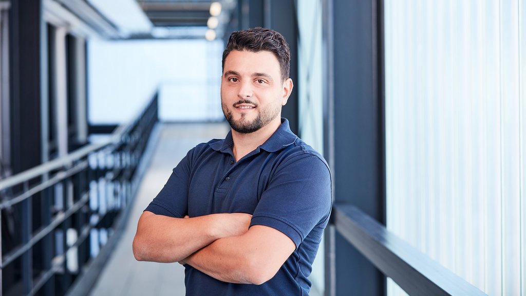 Male employee looks into the camera