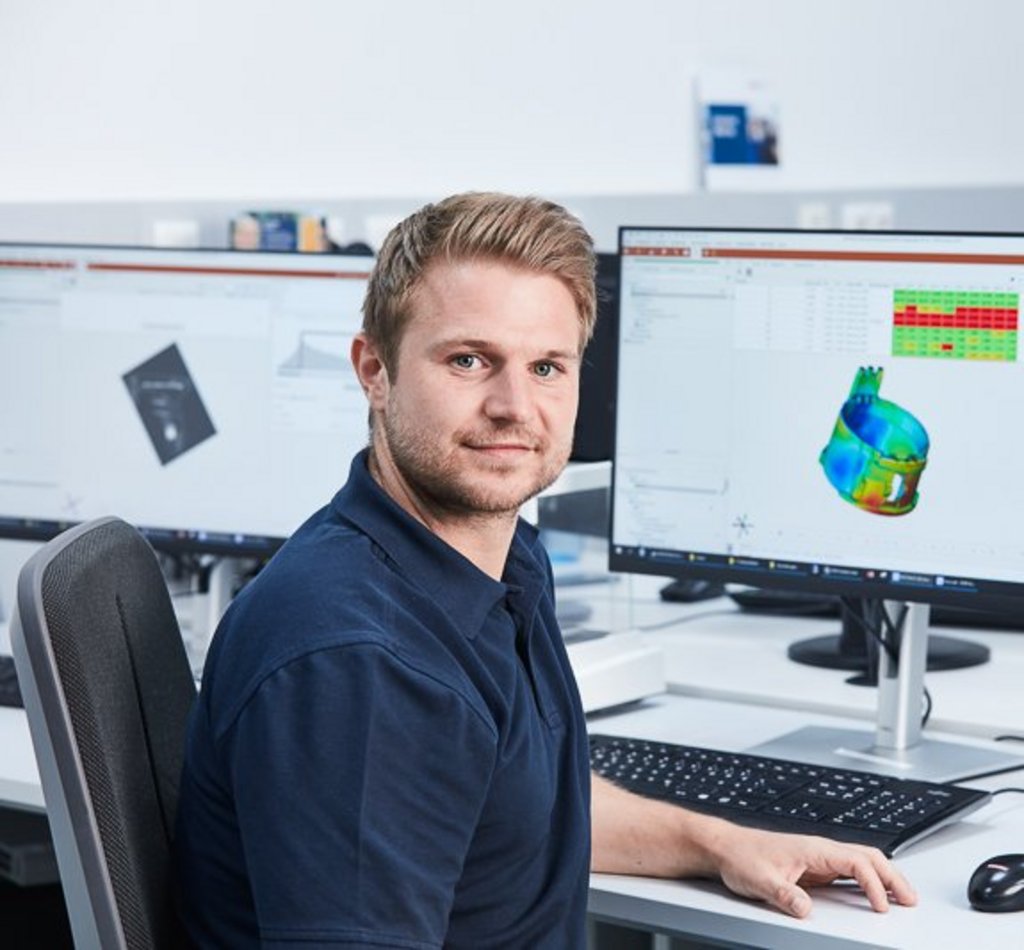 employee on the desk looking into the camera