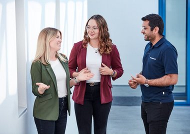 Three employees chatting