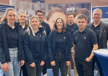 Eight Employees on a fair booth